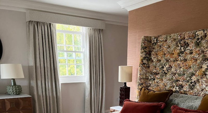Bespoke master bedroom suite with bouclé upholstery and interlined curtains with tailored pelmets, Hertfordshire by Stripe Interiors